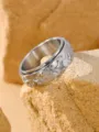 Close-up detail of retro silver spinner ring featuring raised star patterns on stone. - Size 7 / Steel