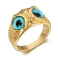 Detailed close-up of vintage gold owl eye stainless steel ring with blue eyes and punk style - Size 7 / Gold & Blue