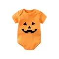 Detailed view of a bright orange baby romper featuring a classic Halloween pumpkin face print. - Newborn / Yellow
