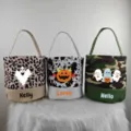 Detailed view of customized Halloween canvas candy baskets with ghost and pumpkin prints. - Printed Style