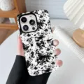 Close-up detail of a fashionable black and white cow print protective phone case - Leopard 3 / iPhone X/XS