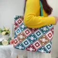 Detailed view of model carrying a large capacity geometric print tote bag in vibrant colors - Boho