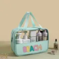 Large mint green PVC semi-transparent beach wash bag filled with skincare bottles - Green