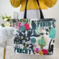A detailed shot of a large canvas tote bag featuring western-themed punchy prints - Cowboy