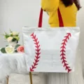 Fashionable large white canvas tote bag featuring red baseball stitch print details - Baseball