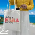 Detail of white canvas tote bag with Being a MAMA makes my life complete floral print - Style 5