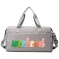 Detailed view of grey sports gym bag featuring colorful weekend chenille patch design - Gray