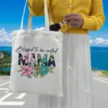 Canvas tote bag with floral MAMA print shown outdoors in lifestyle setting - Style 3