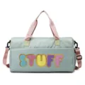 Close-up of mint green duffel bag with colorful STUFF chenille patches and gold borders - Green Pink