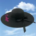 Black straw sun hat with pink Caitlyn embroidery and a elegant ribbon bow detail. - One Size / Black