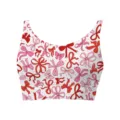 Detailed view of women's cropped tank top featuring pink and red bow print pattern - Bow