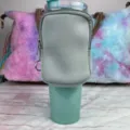 Detail view of a gray neoprene accessory pouch attached to a 40oz teal tumbler - Light Gray