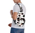 Detailed view of the stylish cow print pattern on a sling bag worn by a male model - Cow Print
