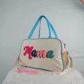 Large capacity multi-colored travel bag featuring Mama chenille embroidery and blue handles - MAMA