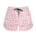 Detailed view of pink checkered sports shorts featuring Mama and flower patterns - S / Bottoms / Pink Plaid