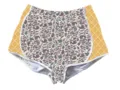 Detailed view of women's camo shorts featuring orange waffle grid side panels - Leopard 1 / S
