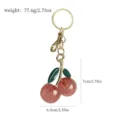 Detailed view of cherry keychain with dimension and weight markers on white background - Red Shimmer