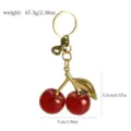 Detailed dimension view of a red glitter cherry keychain with gold leaf hardware - Transparent Pink Glitter