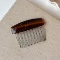 Acetate hair insert comb detail featuring elegant tortoiseshell pattern and cute engraved bows. - Caramel Amber Hair Comb