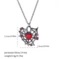 Close-up view of a Gothic spider web heart necklace with red gemstone and size parameters - Spider Web Heart