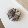 Leopard print hair scrunchie detail view, showing soft fabric texture and handmade tag for daily wear. - Small Scrunchie / Off White