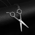 Close-up detailed view of creative silver scissor pendant necklace with textured handles - Gunmetal