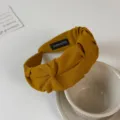 Mustard yellow wide knotted fabric headband stylish hair accessory detail showcase view - Turmeric