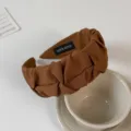 Detailed shot of a stylish brown pleated wide headband, perfect for chic everyday wear. - Coffee