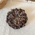 Detailed shot of leopard print hair scrunchie with black lace trim, perfect for daily styling. - Double-Layer Lace Style