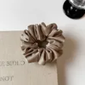 Close-up detail of rhinestone satin hair scrunchie, showing shimmering fabric texture for styling. - S / Beige Coffee