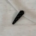 Detailed view of a black snap hair clip with white polka dots, fabric wrapped daily wear. - Waterdrop Clip / Black