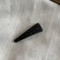 Detailed view of black fabric polka dot snap hair clip, showcasing delicate texture and cute dots. - Black-Triangle Snap Clip