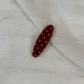 Close-up detail shot of a cute polka dot fabric hair clip, featuring a stylish daily design. - Oval Clip / Red
