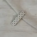 Detailed view of off-white fabric snap hair clip with cute black polka dot pattern design. - Rectangular Clip / Off White