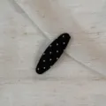 Black and white polka dot fabric snap hair clip detail close-up view, chic cute style. - Oval Clip / Black