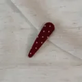 Detail shot of dark red polka dot hair clip fabric wrapped snap pin close up display for styling. - Waterdrop Clip / Red