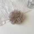 Close-up of a sparkling sheer scrunchie with delicate rhinestones for elegant hairstyles. - S / Champagne