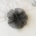 Black sparkly scrunchie detail view, shimmering bubble gauze hair tie for elegant hairstyles. - L / Black