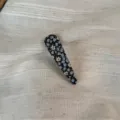 Detailed close-up of a floral fabric snap hair clip, showcasing delicate blue and white floral pattern. - Waterdrop Clip / Blue Floral