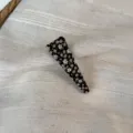 Detailed shot of a floral fabric hair clip with black background, sweet and elegant style. - Triangle Clip / Black Yellow Floral