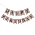 Detail macro view of rustic burlap Happy Birthday banner flags for party decoration - Black Text