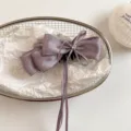 Close-up detail of the elegant purple satin bow hair claw clip with rhinestones and ribbons. - 13cm / Purple