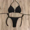 Sexy black split bikini swimsuit featuring a halter top and adjustable side-tie briefs detail. - S / Black