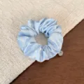 Detailed close-up view of the light blue polka dot hair scrunchie with sweet ruffles. - Sky Blue Polka Dot