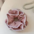 Close-up detail of a sweet pink polka dot hair scrunchie featuring elegant white ruffled edges. - Pink Polka Dot