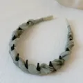 Green satin fabric headband with comb teeth, elegant daily hair accessory detail view. - Headband