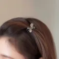 Close-up of a sparkling rhinestone bow hair claw clip, delicate mini hair accessory for side hair. - Crystal Butterfly Small Claw Clip