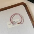 Exquisite pink pearl hair tie elastic band detail view, elegant small hair accessory for women. - Pink