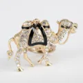 Close-up detail of glittering rhinestone gold camel animal keychain and bag charm ornament. - Gold & Black