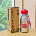 Detail shot of creative stainless steel vacuum water bottle with cute apple lid and charm. - 380ml / Apple